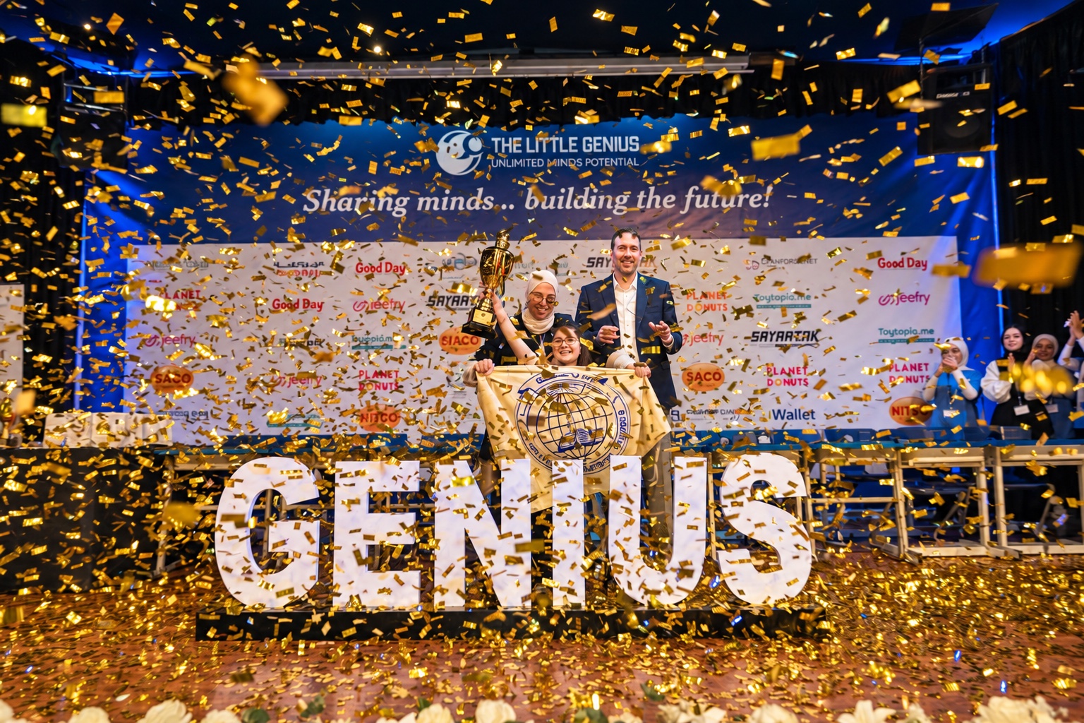 A winner celebrating on the Little Genius competition stage